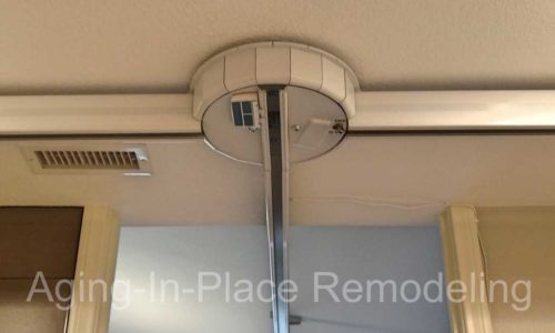 Patient ceiling lift transfers to tile barrier free shower, wall mounted toilet and walk-in tub for complete wheelchair accessibility