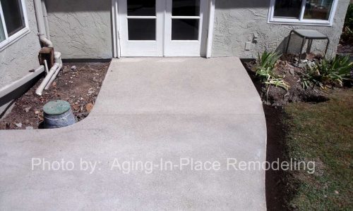 Custom concrete sloping entry to back door