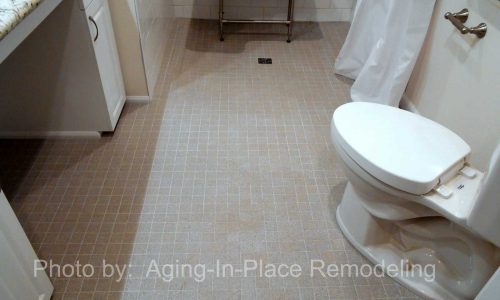 Wheelchair Accessible bathroom remodel with barrier free roll in shower, fold up shower seat, grab bars, hand held shower head, wheelchair accessible roll under sink