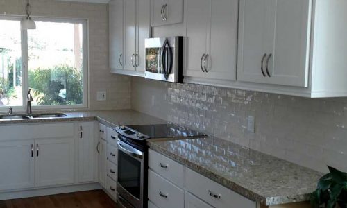 Kitchen Remodel with classic white cabinets and back splash, quartz counter tops, stainless steel appliances for a sleek modern look