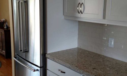 Kitchen Remodel with classic white cabinets and back splash, quartz counter tops, stainless steel appliances for a sleek modern look