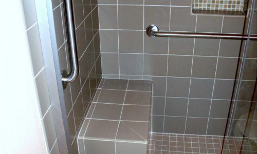 Bathroom remodel with low threshold shower, built in shower bench, grab bars and custom tile
