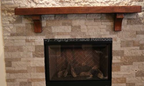 A stone wall creates a beautiful surround for the updated fireplace