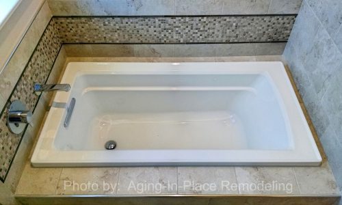 Wheelchair accessible bathroom remodel with roll-in shower, custom tile shower, grab bars