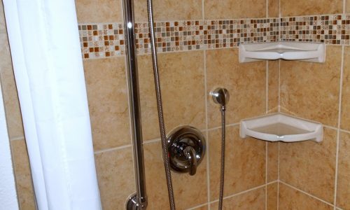 Barrier Free Bathroom Remodel, grab bars, fold up shower seat, tile roll in shower, accessible renovations, aging in place remodeling, roll under wheelchair accessible sink