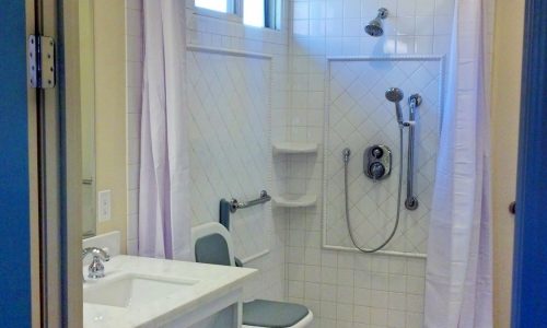 Wheelchair Accessible bathroom remodel with tile roll-in shower, custom roll under sink, fold up shower seat, accessible renovations, aging in place remodeling