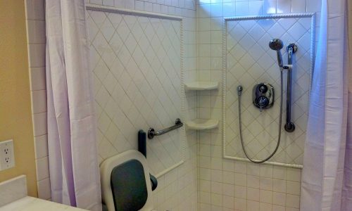 Wheelchair Accessible bathroom remodel with tile roll-in shower, custom roll under sink, fold up shower seat, accessible renovations, aging in place remodeling