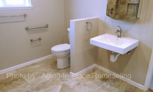 Wheelchair accessible roll under sink in newly remodeled bathroom with barrier free, roll-in shower