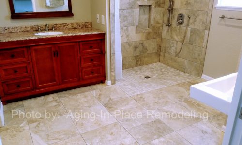 Custom Tile barrier free, roll-in shower with hand held shower head allows for wheelchair accessibility, with roll under sink for complete accessibility