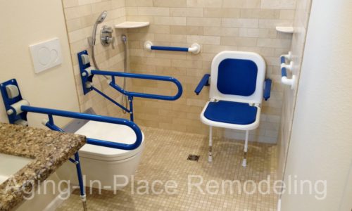 Accessible bathroom remodel, wall mount toilet, fold up shower seat, grab bars, wheelchair accessible sink and ceiling lift for safe transfer of client