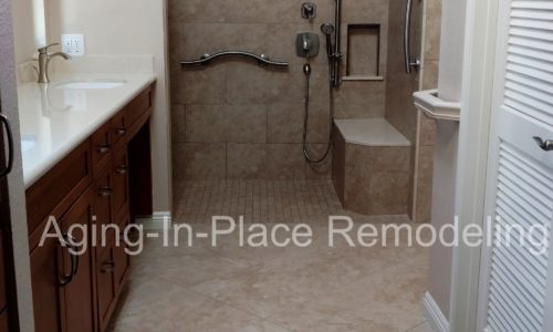 Custom tile shower remodel with built in bench, custom grab bars, hand held shower head, wheelchair accessible, roll-in shower