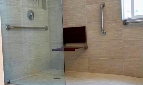 Accessible bathroom remodel with tile roll-in shower, roll under sink, fold up shower seat and grab bars