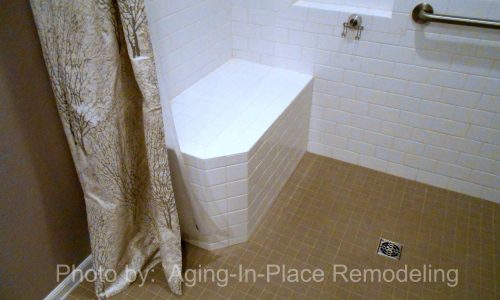 Wheelchair accessible bathroom remodel with barrier free roll in shower, grab bars, hand held shower head, roll under wheelchair accessible sink