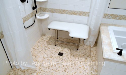 Accessible Renovations wheelchair accessible bathroom remodel with tile roll-in shower, grab bars and fold up shower seat