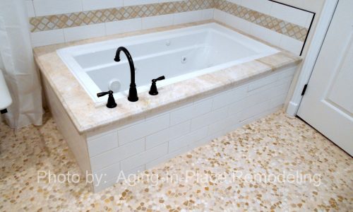 Accessible Renovations wheelchair accessible bathroom remodel with tile roll-in shower, grab bars and fold up shower seat