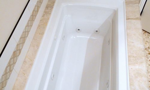 Accessible Renovations wheelchair accessible bathroom remodel with tile roll-in shower, grab bars and fold up shower seat