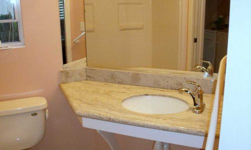 Bathroom remodel for accessibility includes wheelchair accessible roll under sink and Best Bath fiberglass roll in shower