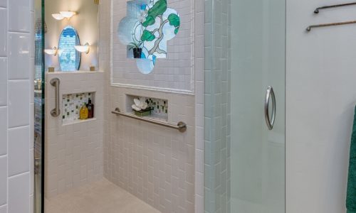 His and Her barrier free shower with custom tile accents and grab bars for added safety