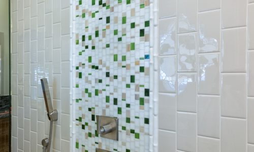 His and Her barrier free shower with custom tile accents and grab bars for added safety