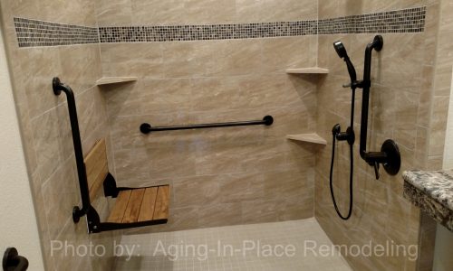 Wheelchair accessible bathroom remodel with tile roll-in shower, roll under sink, fold-up shower seat and grab bars