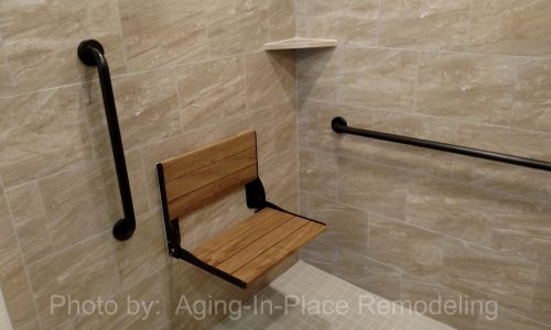 Wheelchair accessible bathroom remodel with tile roll-in shower, roll under sink, fold-up shower seat and grab bars
