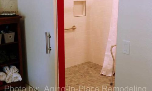 A barn door allows for a larger, more accessible opening to a Custom Barrier Free Shower