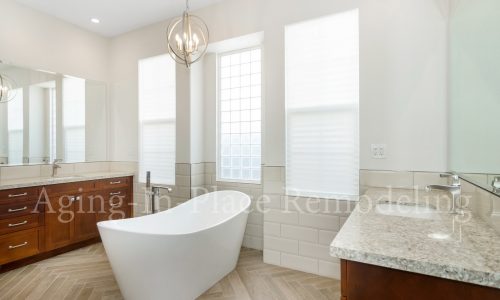 Bathroom remodel with low threshold shower, elegant flooring and gorgeous fixtures