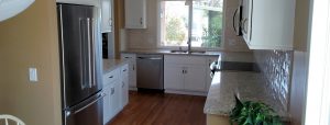 Kitchen Remodel with classic white cabinets and back splash, quartz counter tops, stainless steel appliances for a sleek modern look