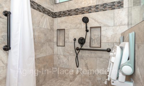 Roll in shower with fold down, wall-mounted shower seat, hand held shower head, grab bars, custom tile