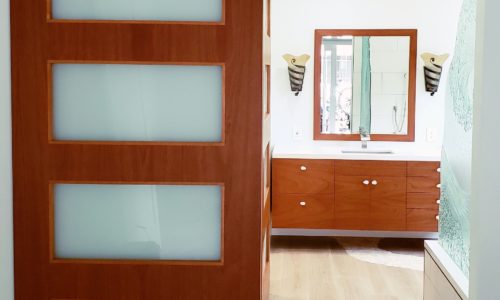 A master bathroom remodel creating a wheelchair accessible space.  Automated barn doors for easier entry.