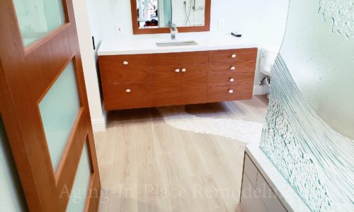 This master bathroom remodel includes a barrier free shower, custom glasswork and tile.