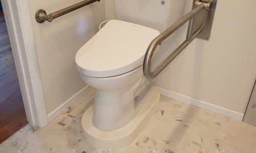 A fold up safety rail provides toileting assistance.