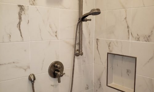 A hand held shower head makes for easier bathing from a wheelchair